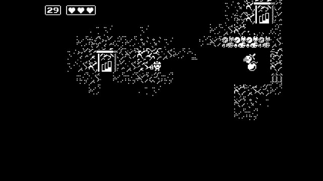 Minit screenshot of main character in mines standing next to a bomb