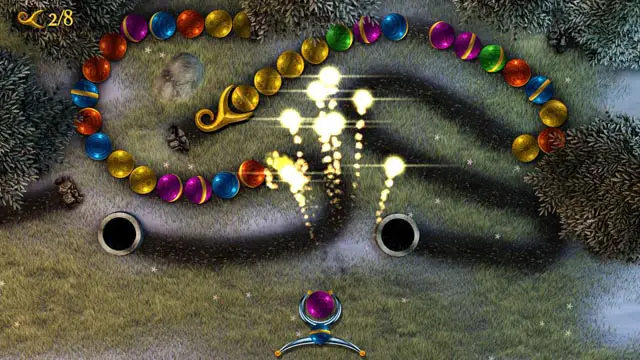 Sparkle Unleashed screenshot; ball at bottom of screen shooting fireworks at balls on the puzzle track above