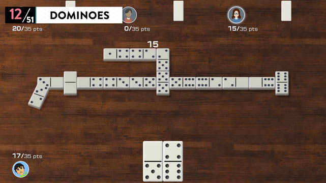 Domino pieces connected to each other atop a wooden table