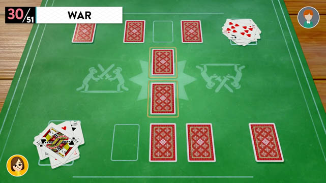 Cards placed upside down on a green tabletop in a game of War