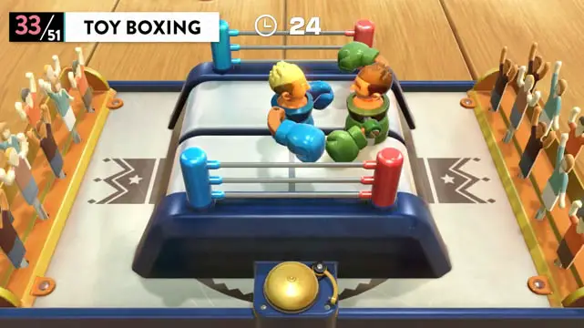 Two toy players in a miniature boxing ring boxing each other