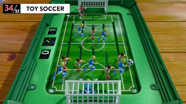 Multiple toy players on a miniature soccer court playing soccer