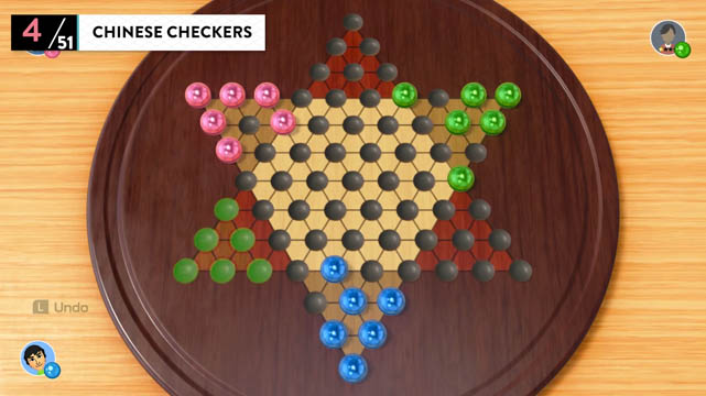 A Chinese checkers game board with colorful marbles set in sockets
