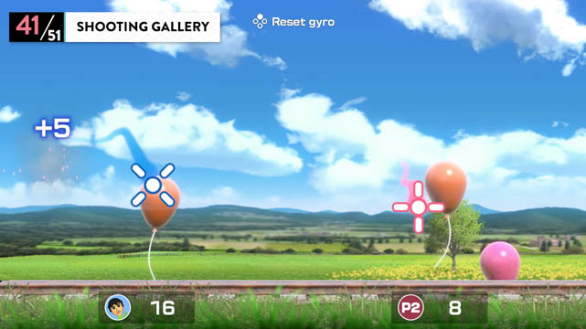 A blue sky and mountain scene with floating balloons in front of it being popped by the players reticule