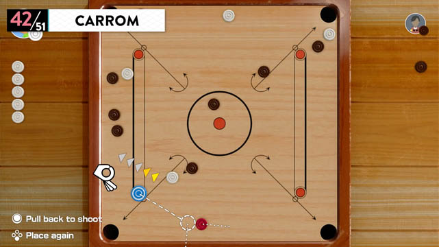 An overhead view of a carrom table with round tokens on top of it