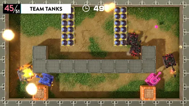 A top down view of multiple toy tanks battling each other in a battleground filled with crates