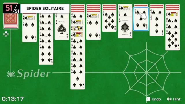 Solitaire playing cards placed on top of a green tabletop