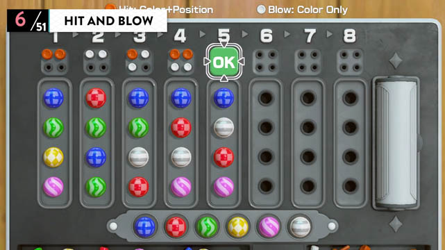 A gray board with marbles set in sockets to represent the Hit and Blow game