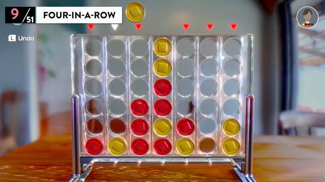 A connect four tabletop device with red and yellow coins inserted in the device