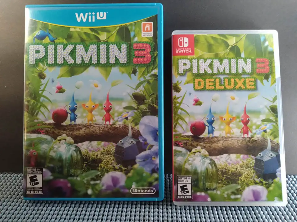Pikmin 3 game cases for Nintendo Wii U and Nintendo Switch resting next to each on a table