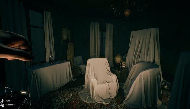 A darkly lit creepy room with furniture covered in white sheets