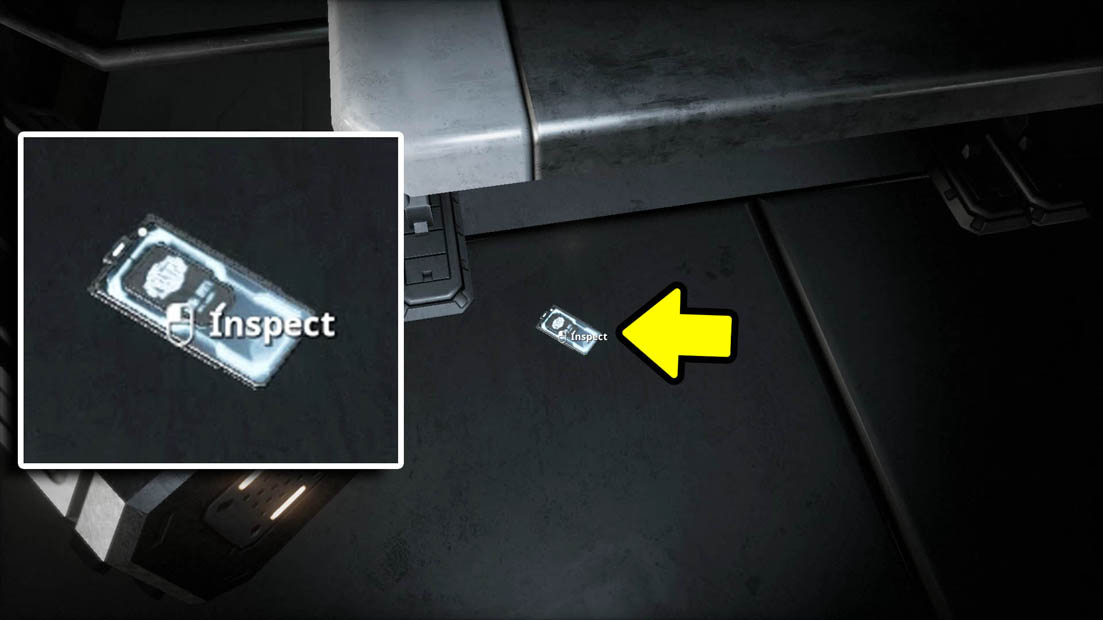 A close up of a key card next to a key card beneath a bench with a yellow arrow pointing at the keycard