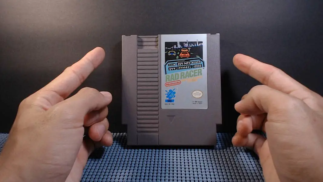 a pair of hands motioning to a video game cart