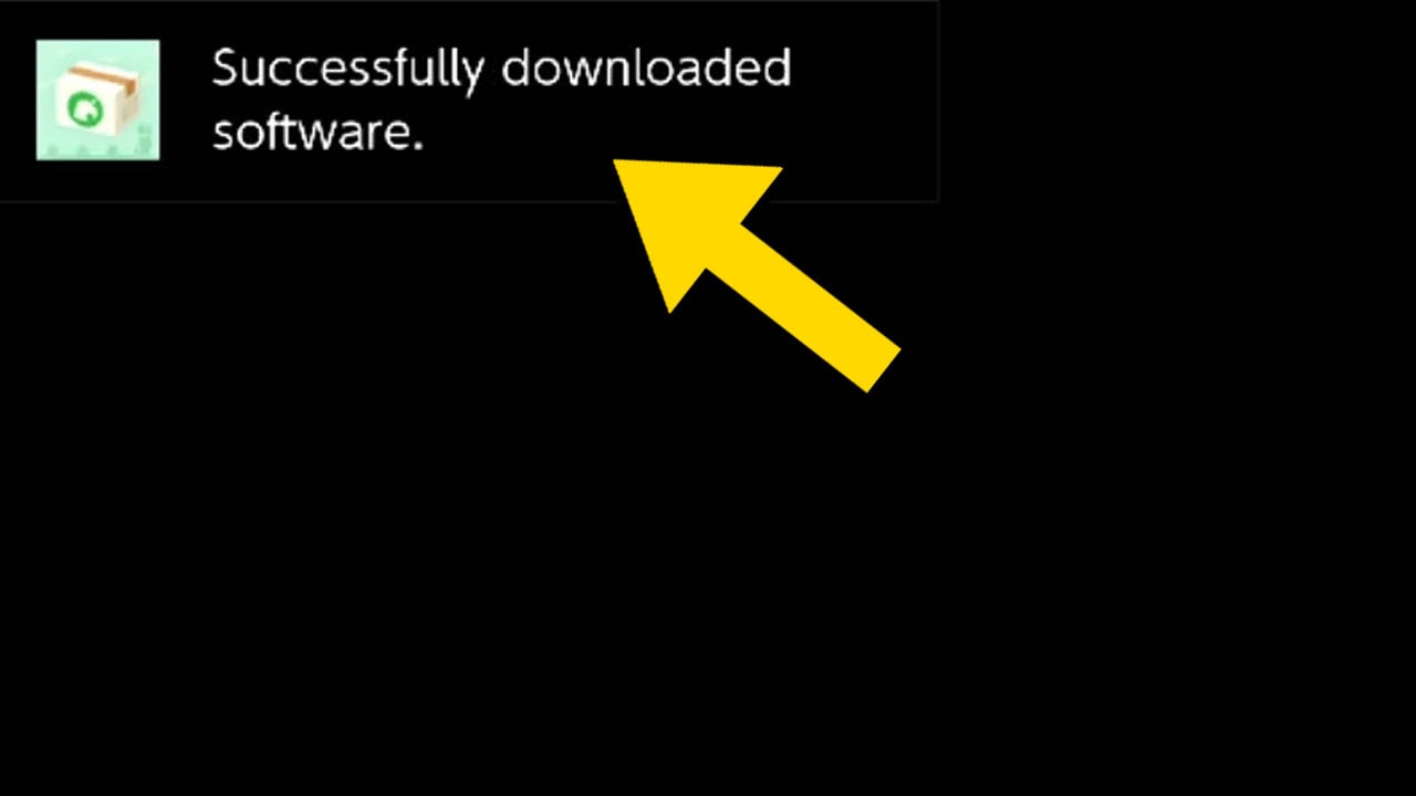 A black screen with a yellow arrow pointing at an on-screen message alert in the top left corner