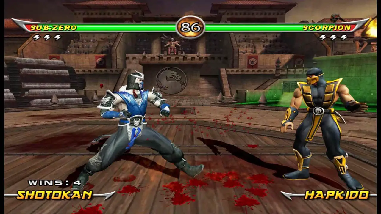 A blue man fighting a yellow man with blood on the ground