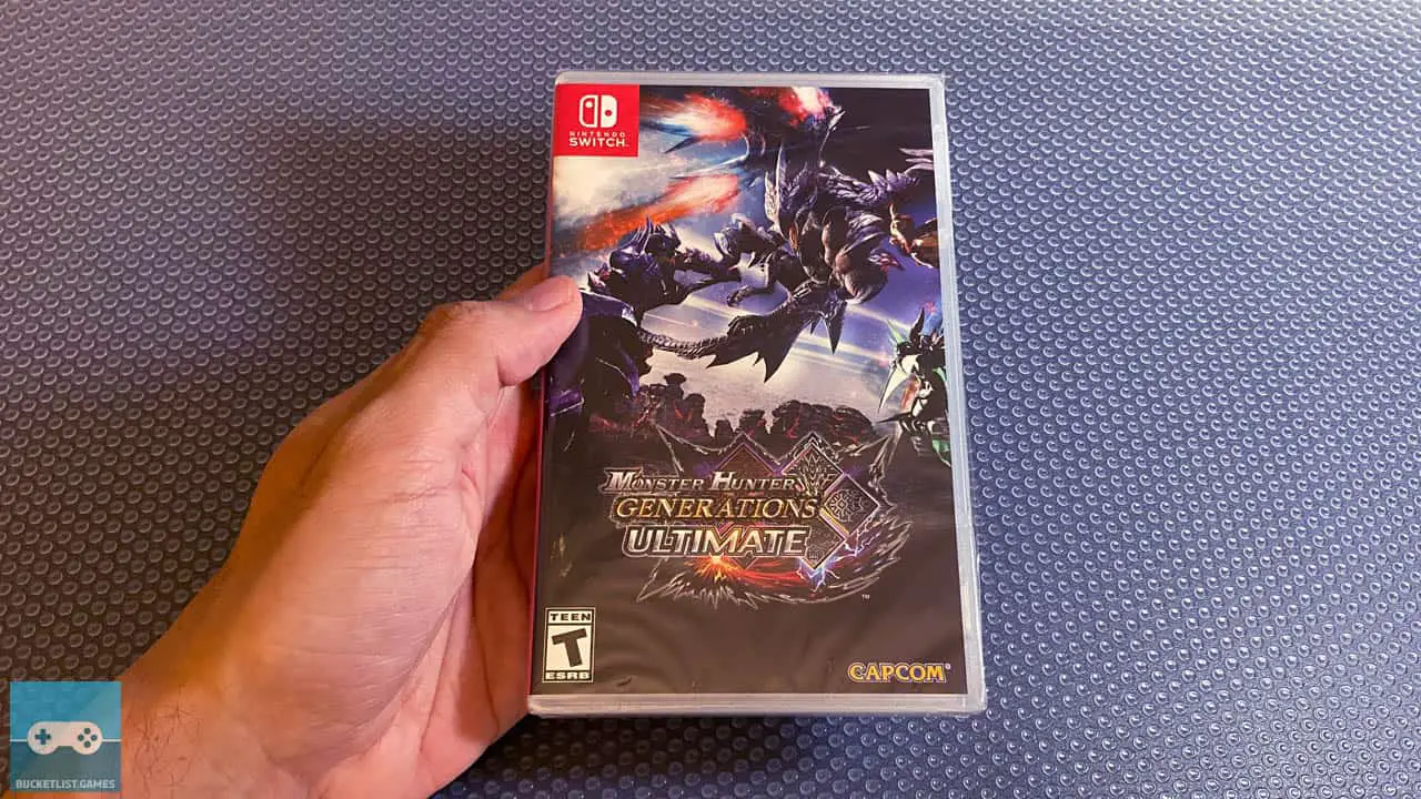a hand holding a monster hunter generations ultimate box on top a table