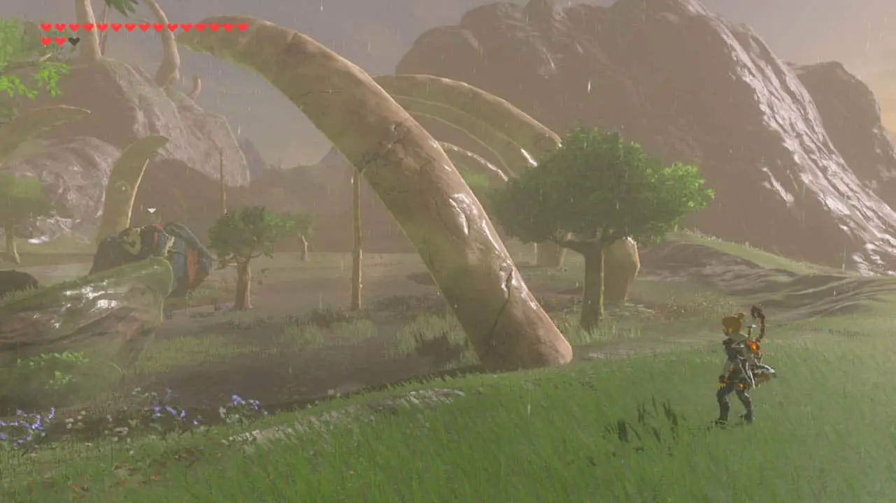 a wide view of green grass and a small man looking at a monster (zelda breath of the wild screenshot)