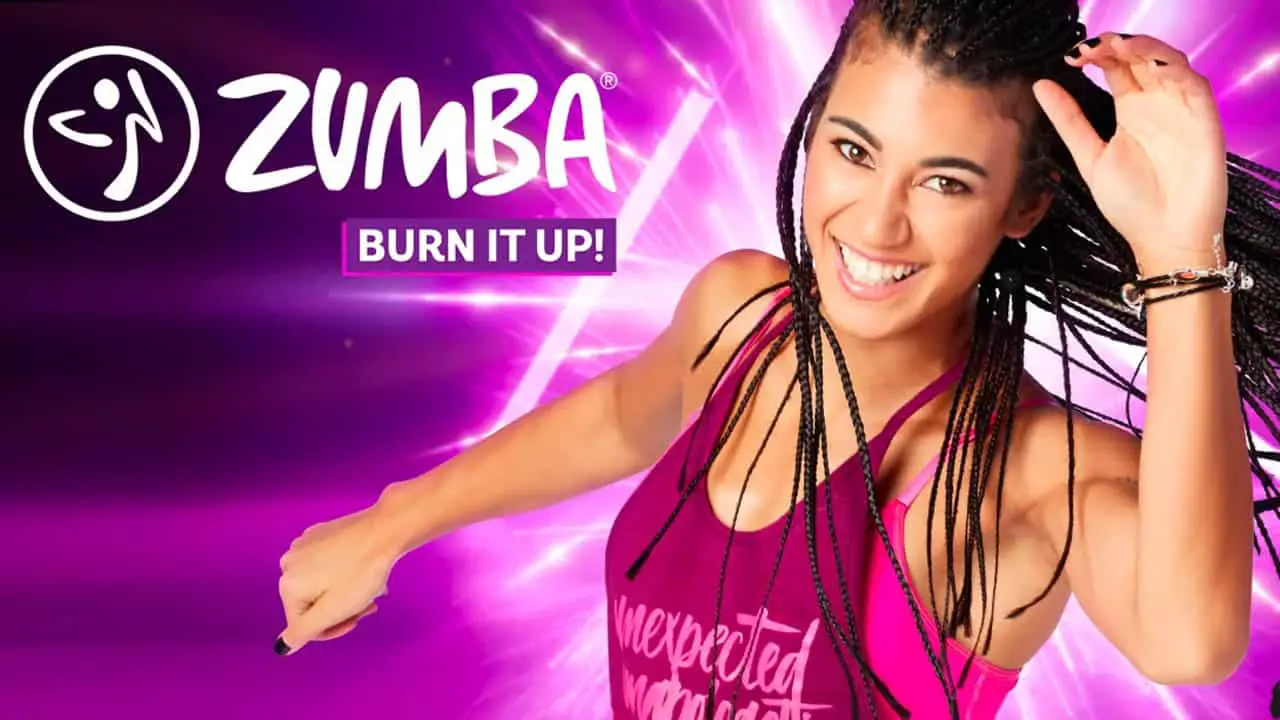 a happy lady dancing zumba in front of a purple background
