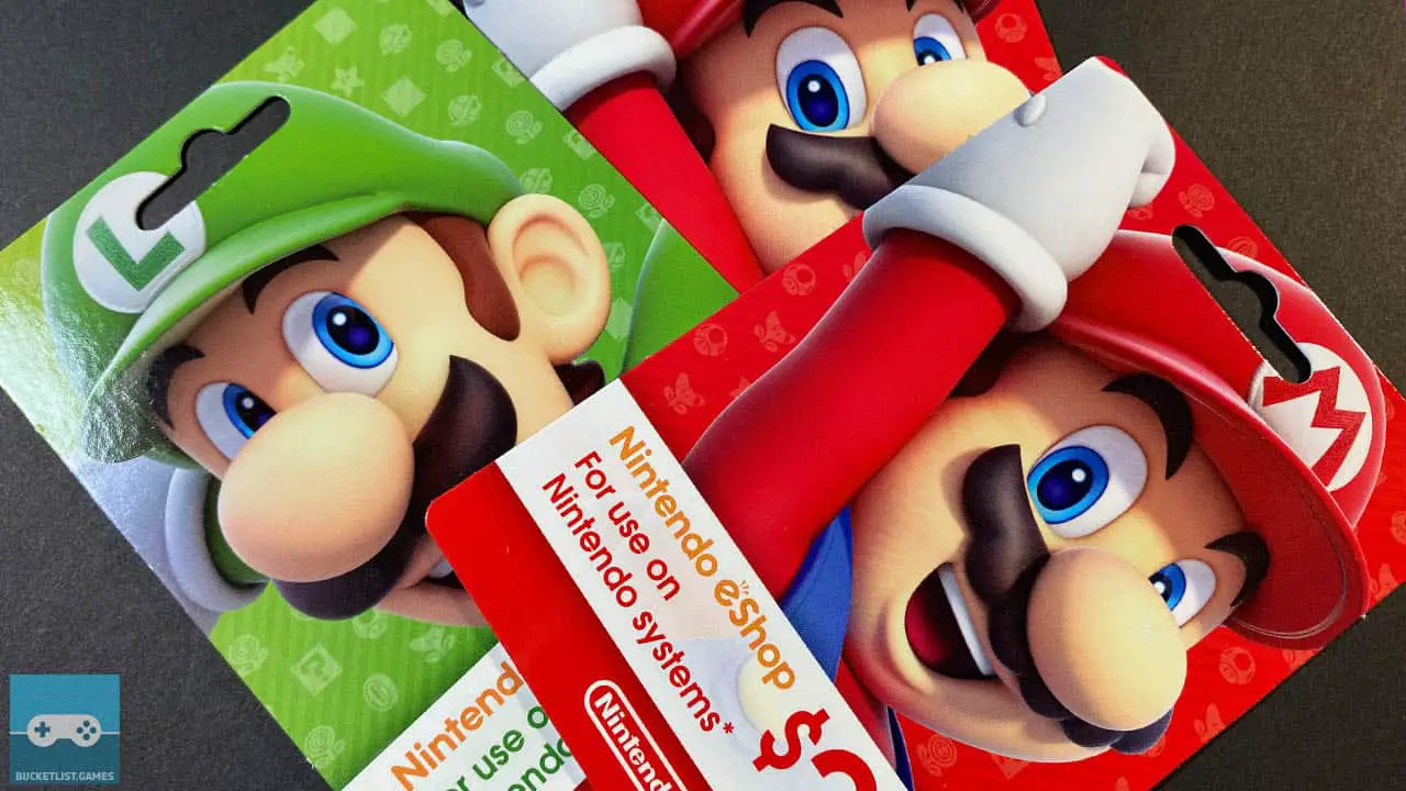 three nintendo gift cards on a table