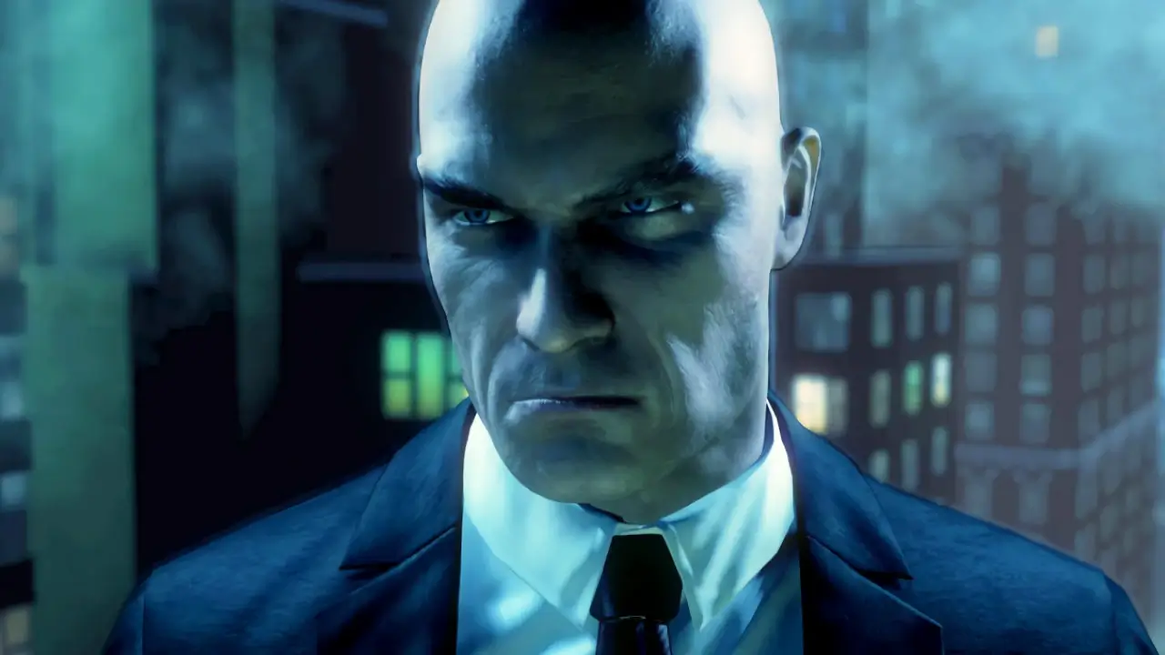 hitman bald guy face close up not smiling wearing suit in front of cityscape